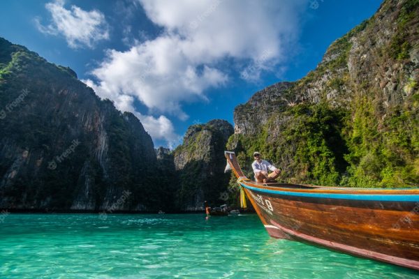 handsome-male-cruising-retro-wood-boat-by-andaman-sea-him-you-can-see-ko-phi-phi-lee-island_264277-144[1]